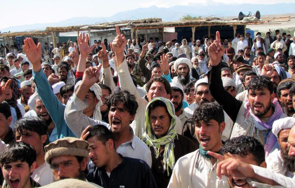 Afghans protest the killing of two civilians during a joint Afghan-NATO raid early Tuesday
